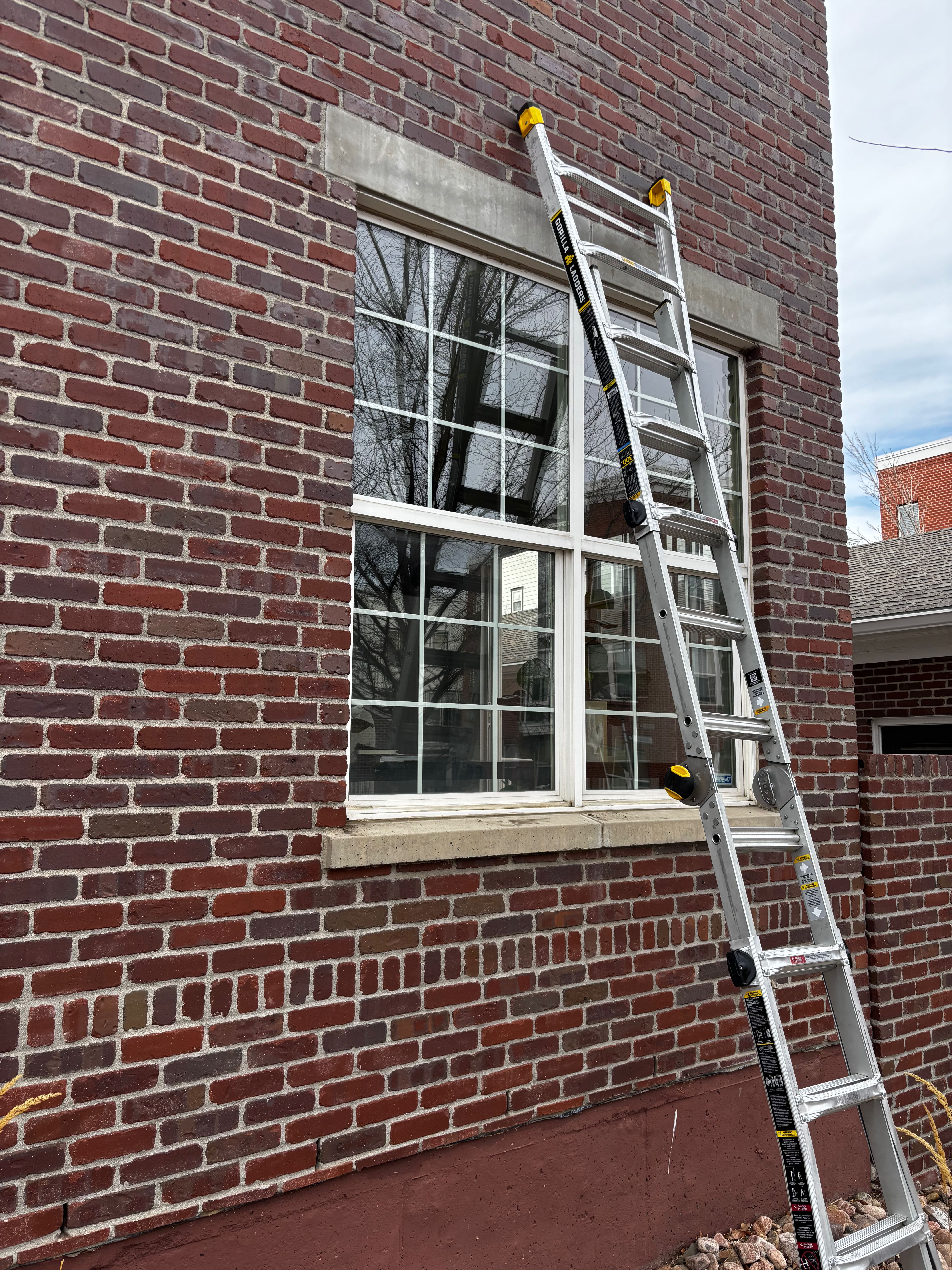 Brick building with ladder for window service
