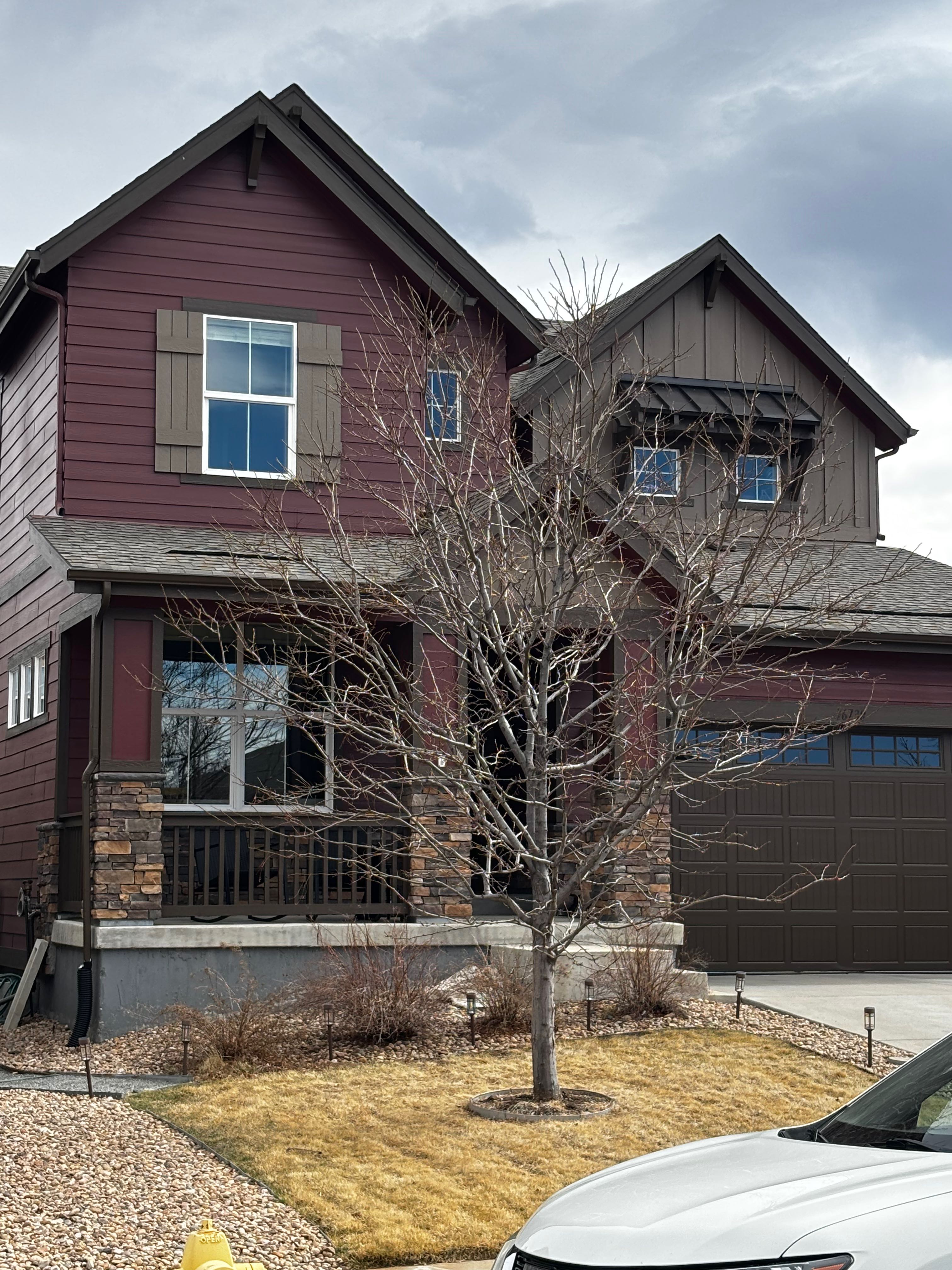 Red house exterior with tinted windows